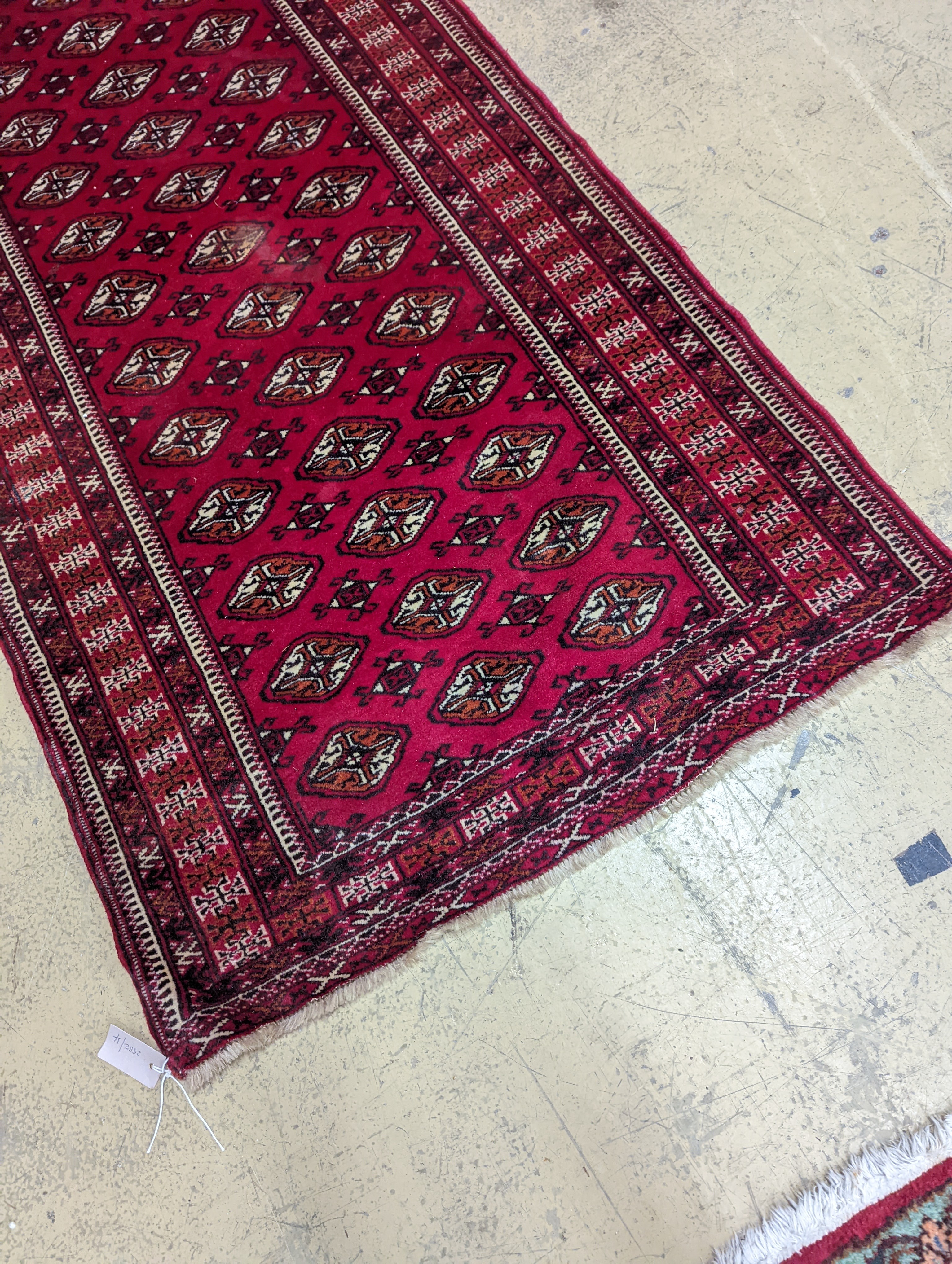 A Bokhara red ground runner, 364 x 98cm